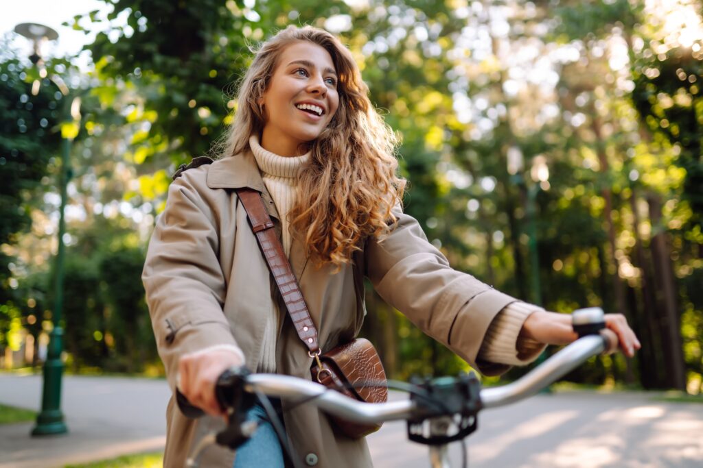 woman riding bike through the woods
