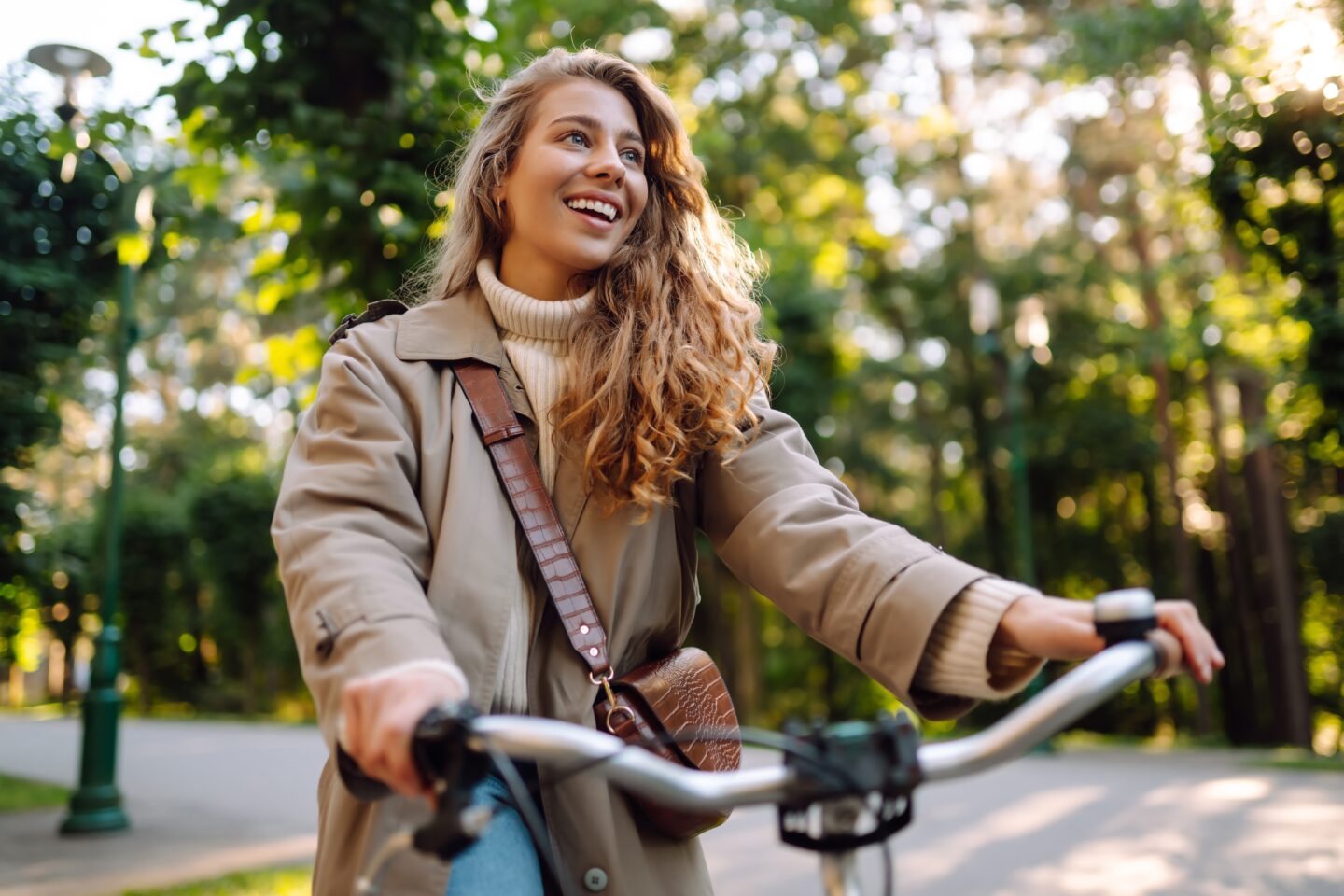 woman riding bike through the woods