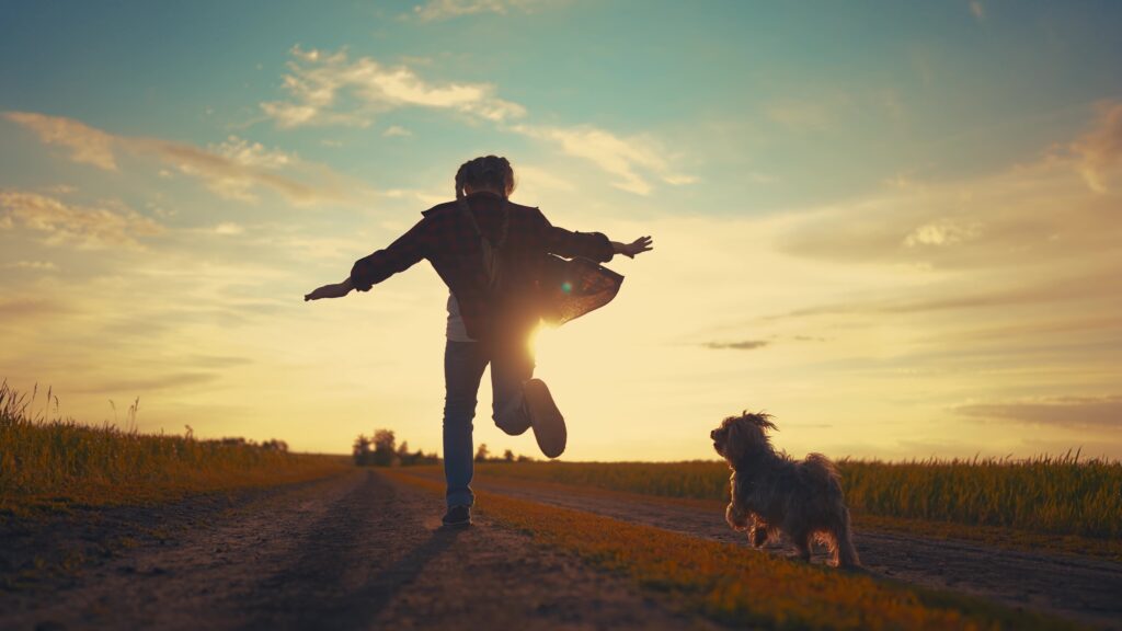 girl running with her dog outside